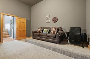 Settle into this cozy living room where a plush sofa and comfortable seating await your movie nights. Charming decor adds character, while soft carpet underfoot creates a welcoming retreat after your 