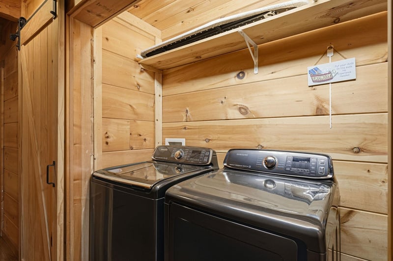 Your dedicated laundry room features a modern washer and dryer set in a charming woodpaneled space, making it easy to refresh your wardrobe during your stay.