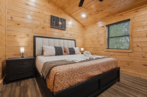 Drift off in your cozy cabin bedroom, where warm wood walls and soft linens create the perfect retreat after your adventures.
