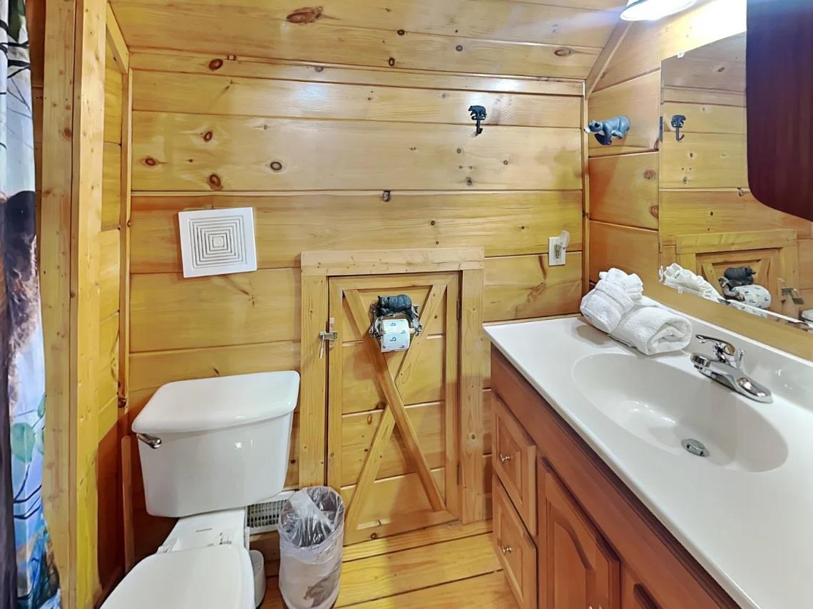Relax in your private bathroom with warm pine finishes, fresh towels, and a cozy cabin feel that makes you feel right at home.
