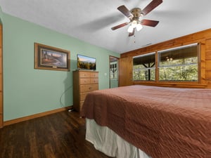 Rest comfortably in your serene bedroom with calming mint walls and forest views from your window.