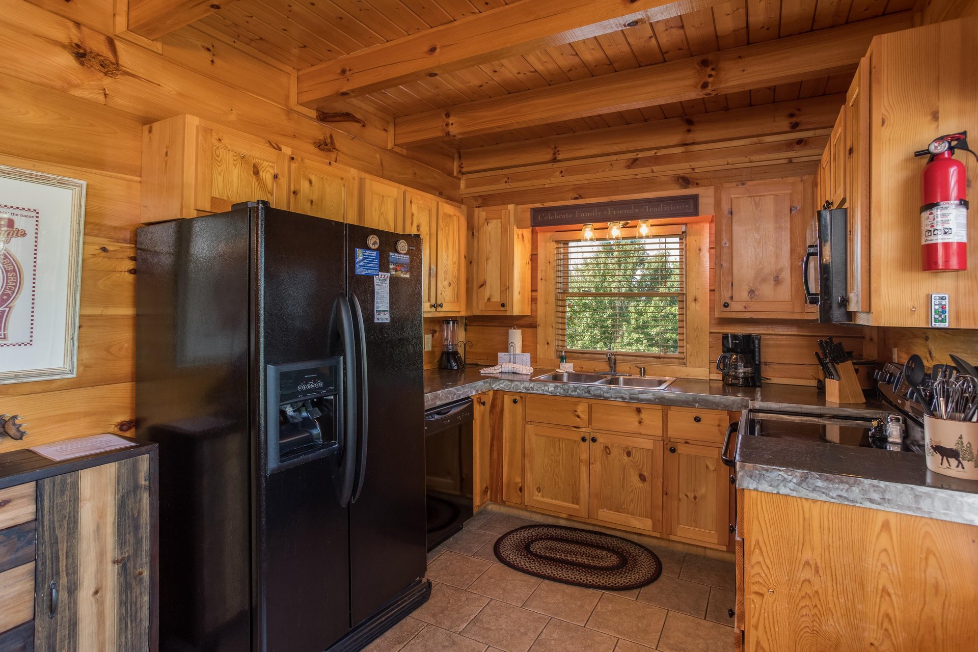 Kitchen with black appliances at Graceland, a 4bedroom cabin rental located in Pigeon Forge