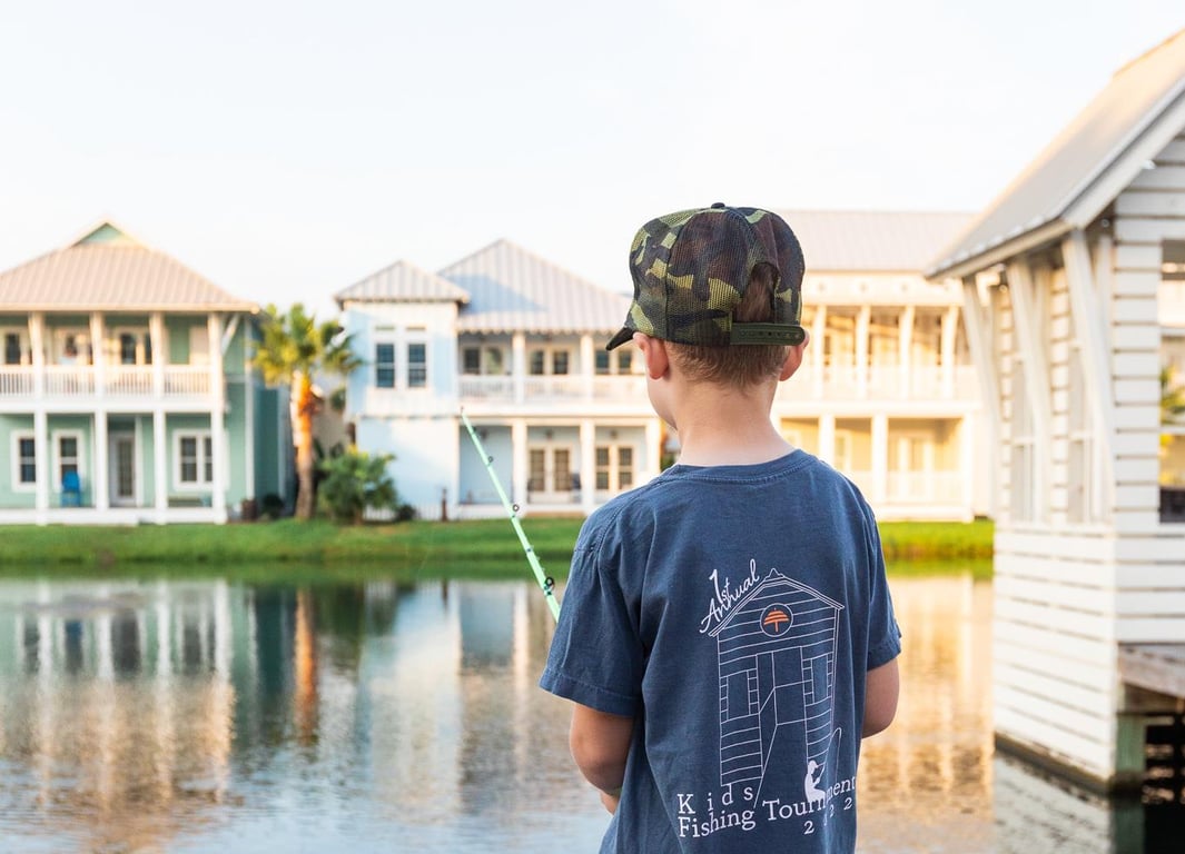 Child fishing beside a lake at Cinnamon Shore in Port Aransas, Texas
