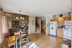 Settle into your cozy openconcept space where warm wood tones and mountain charm create the perfect retreat for memorable meals.