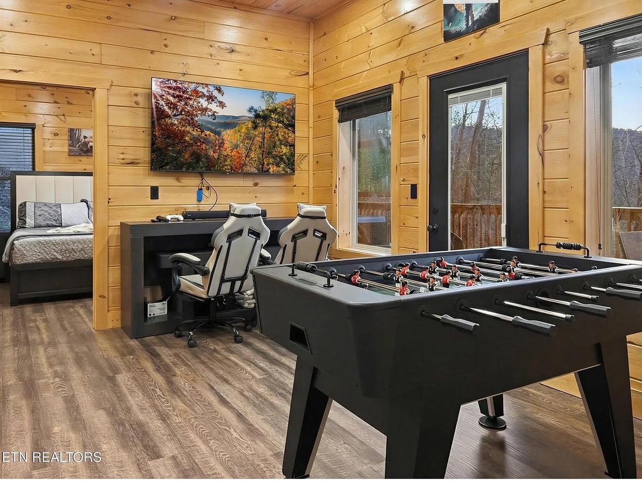 Challenge friends to foosball in your game room, then unwind with gaming chairs and bigscreen entertainment in this cozy cabin retreat.