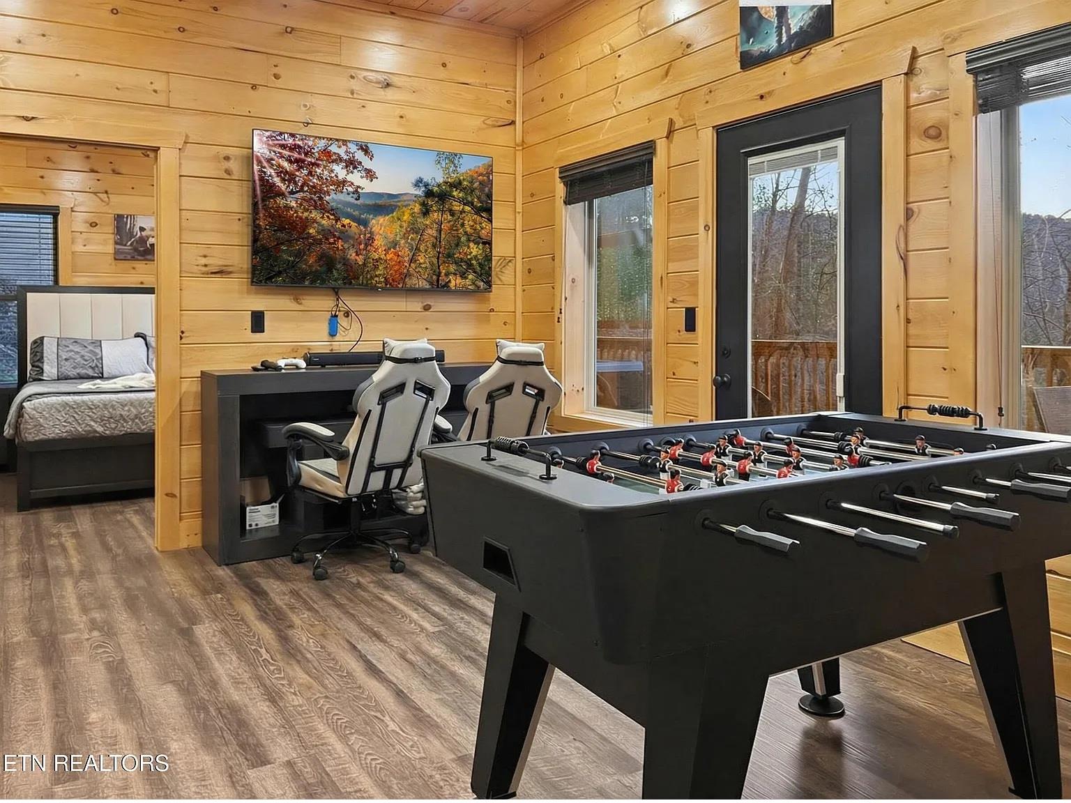 Challenge friends to foosball in your game room, then unwind with gaming chairs and bigscreen entertainment in this cozy cabin retreat.