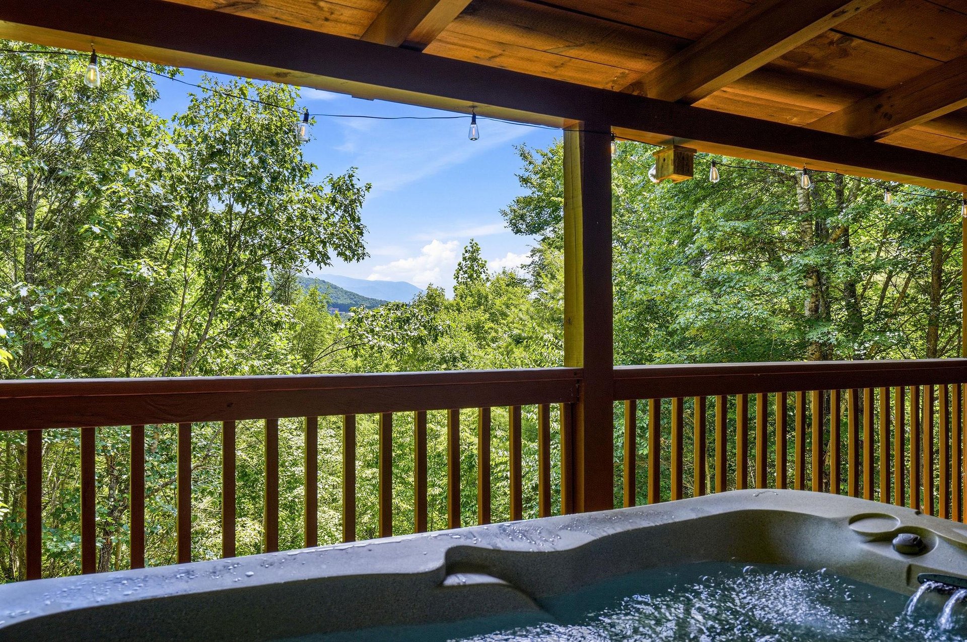 Soak away your cares in the bubbling hot tub on your private covered deck, surrounded by lush forest and framed by mountain views.