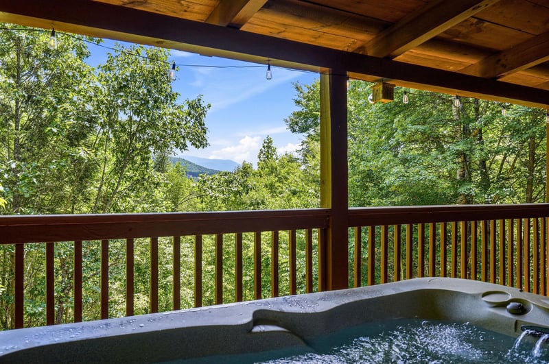 Soak away your cares in the bubbling hot tub on your private covered deck, surrounded by lush forest and framed by mountain views.