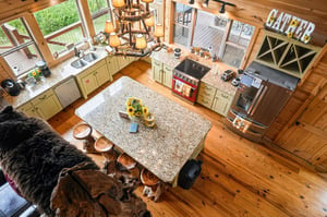Your gourmet kitchen awaits, with polished granite countertops, professionalgrade stove, and a spacious island perfect for preparing feasts. Warm wood floors and rustic charm create a welcoming heart