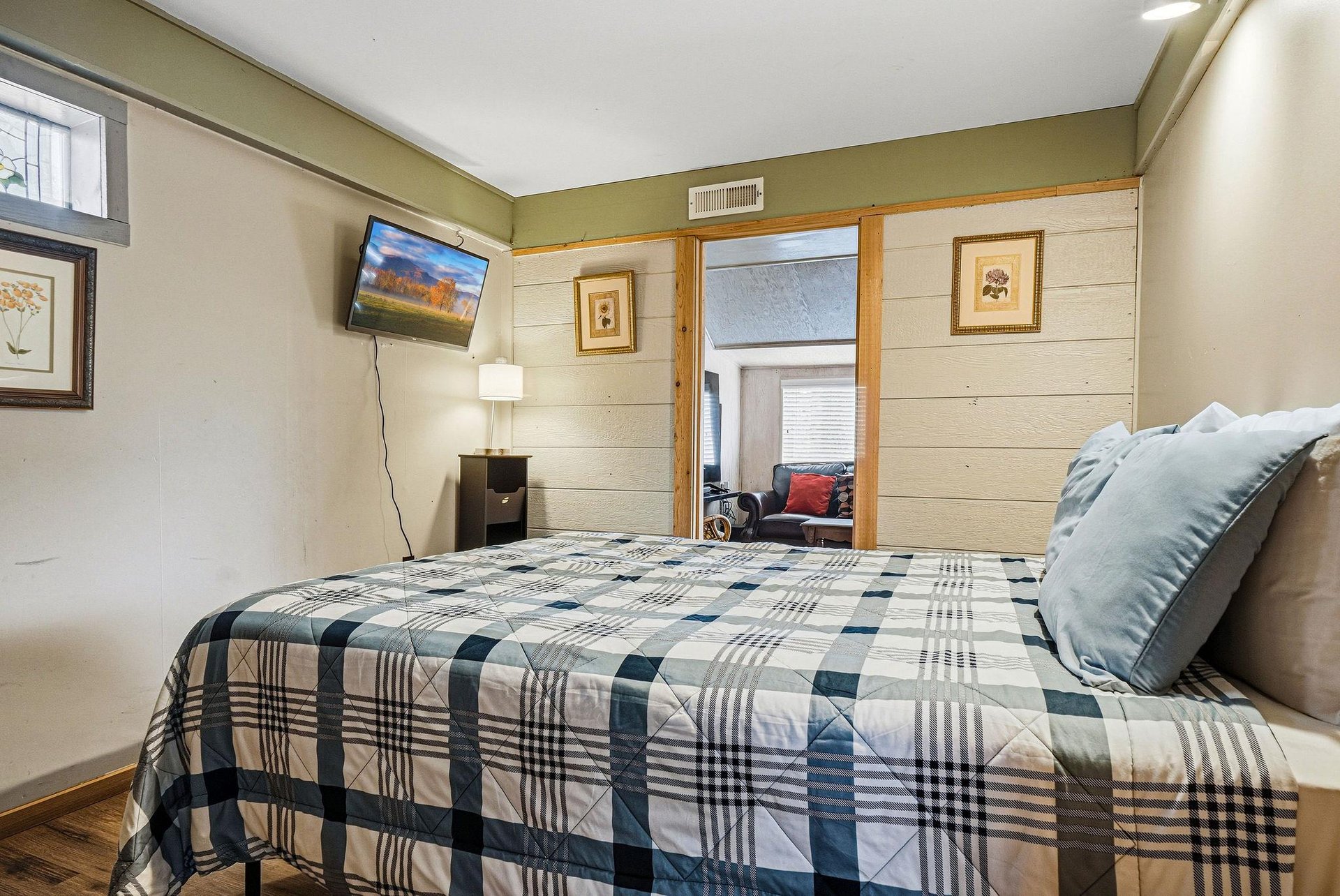 Settle into your cozy bedroom with mountain views on TV, soft bedding, and thoughtful touches like artwork and warm lighting.