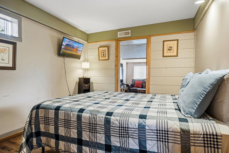 Settle into your cozy bedroom with mountain views on TV, soft bedding, and thoughtful touches like artwork and warm lighting.