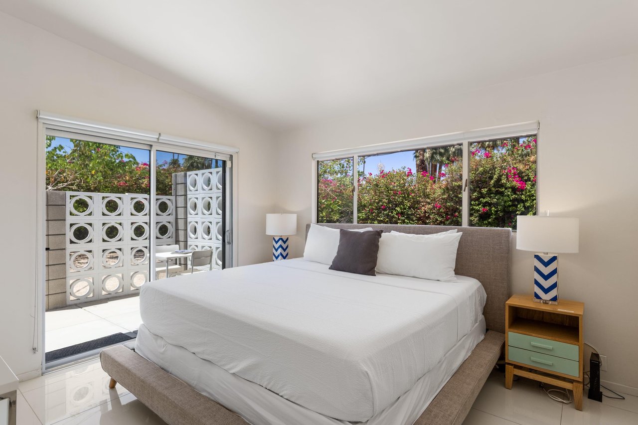 Queen size bed, patio access, and flatscreen TV.