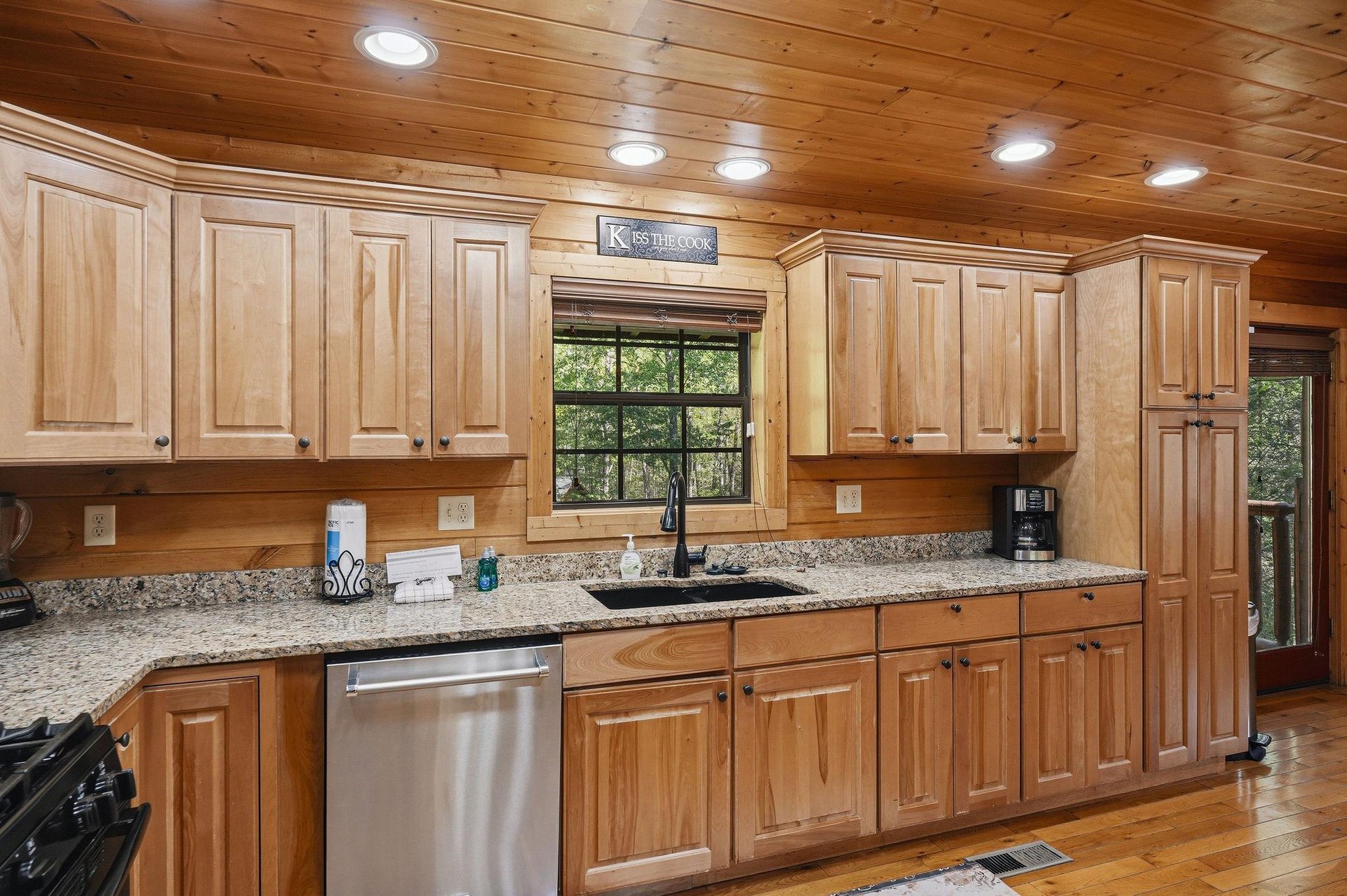 Your fully equipped kitchen features granite countertops, stainless steel appliances, and warm wood cabinetry—perfect for preparing memorable meals during your stay.