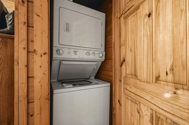 A convenient washer and dryer combo nestled in warm wood cabinetry ensures your vacation wardrobe stays fresh throughout your stay.