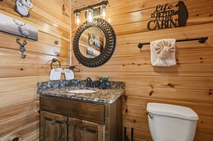 Step into your cozy cabin bathroom where rustic charm meets comfort. Warm wood walls, charming décor, and thoughtful touches create a welcoming retreat after your mountain adventures.