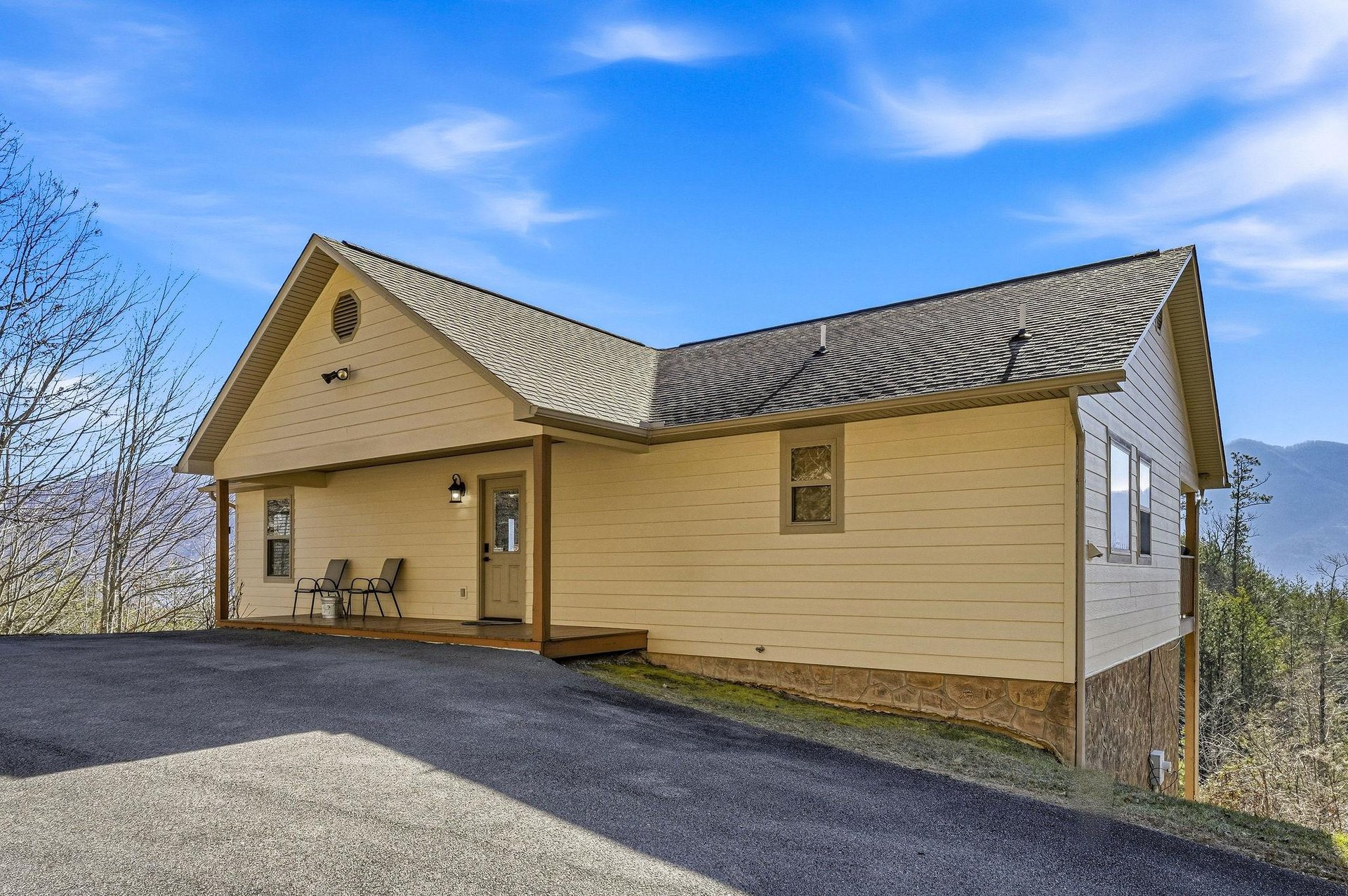 Charming mountain cabin with welcoming porch and panoramic views, offering peaceful retreat surrounded by natural beauty and fresh mountain air.