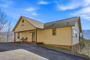 Charming mountain cabin with welcoming porch and panoramic views, offering peaceful retreat surrounded by natural beauty and fresh mountain air.