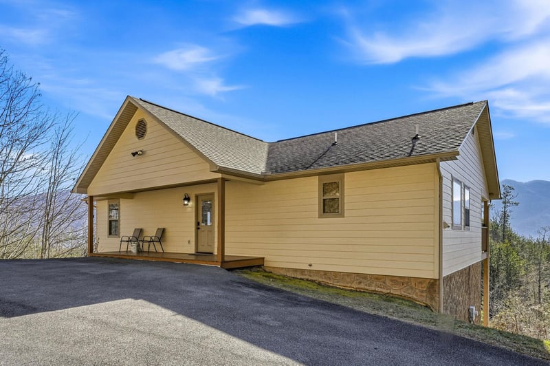 Charming mountain cabin with welcoming porch and panoramic views, offering peaceful retreat surrounded by natural beauty and fresh mountain air.