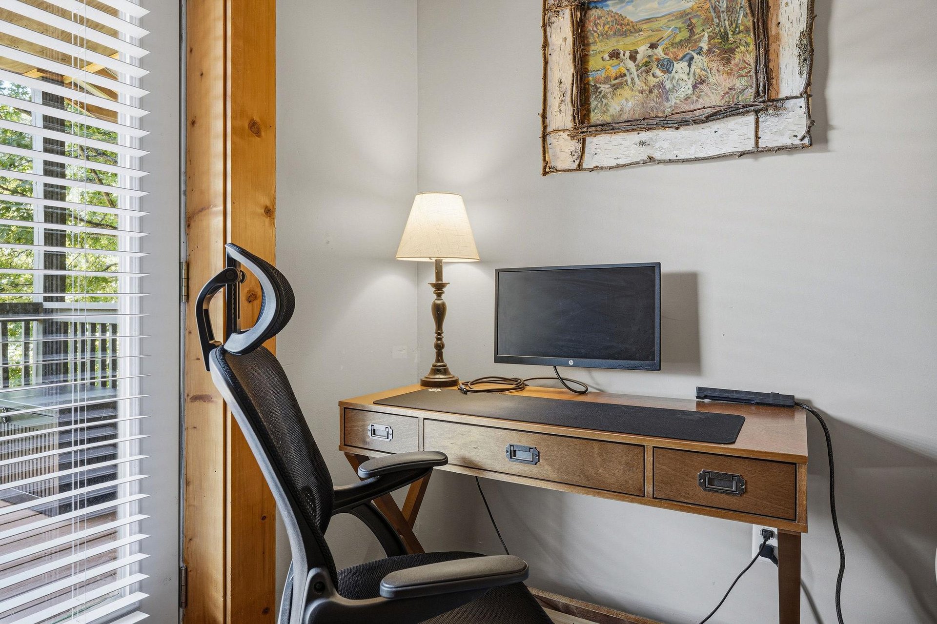 Settle into your dedicated workspace, bathed in natural light from the window, with a vintage desk and rustic charm to inspire your remote workdays.