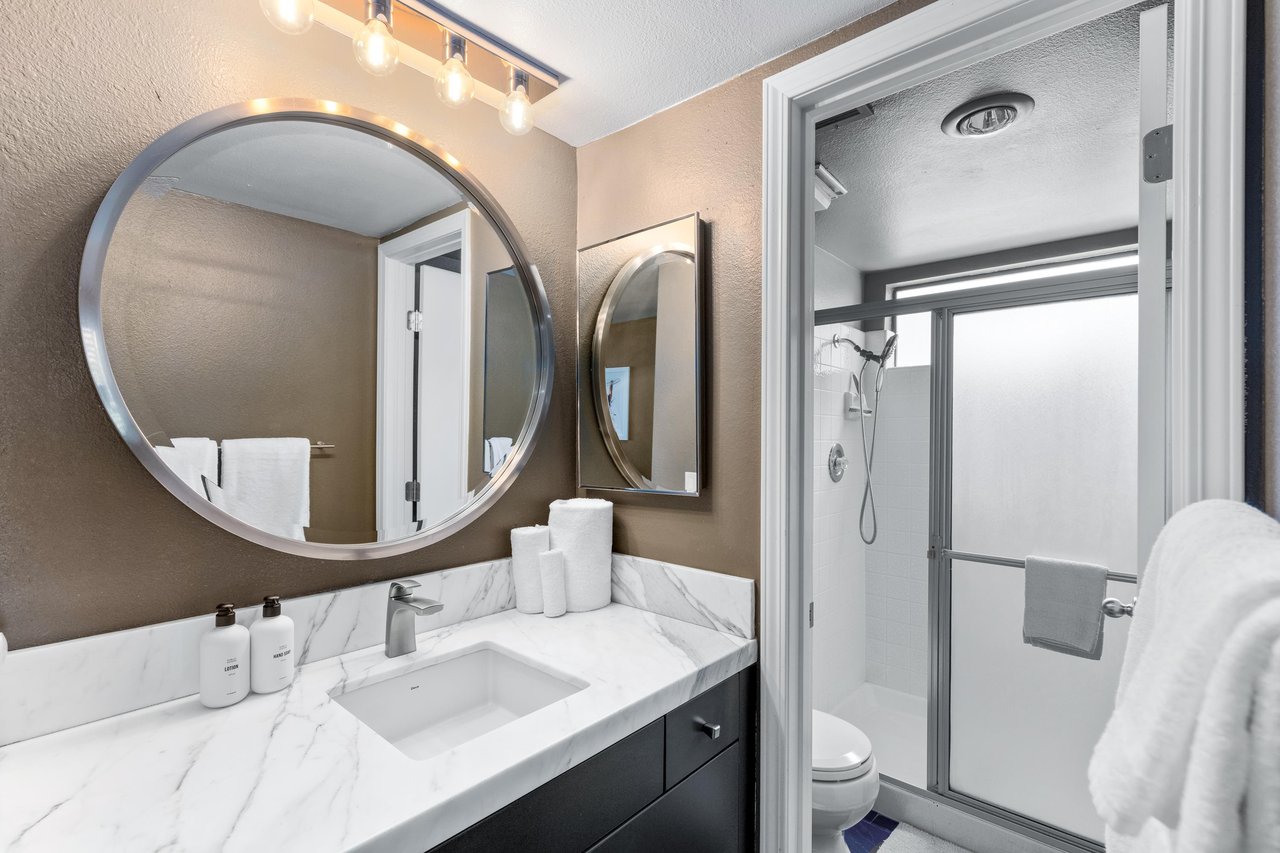 Modern fixtures and standalone shower.