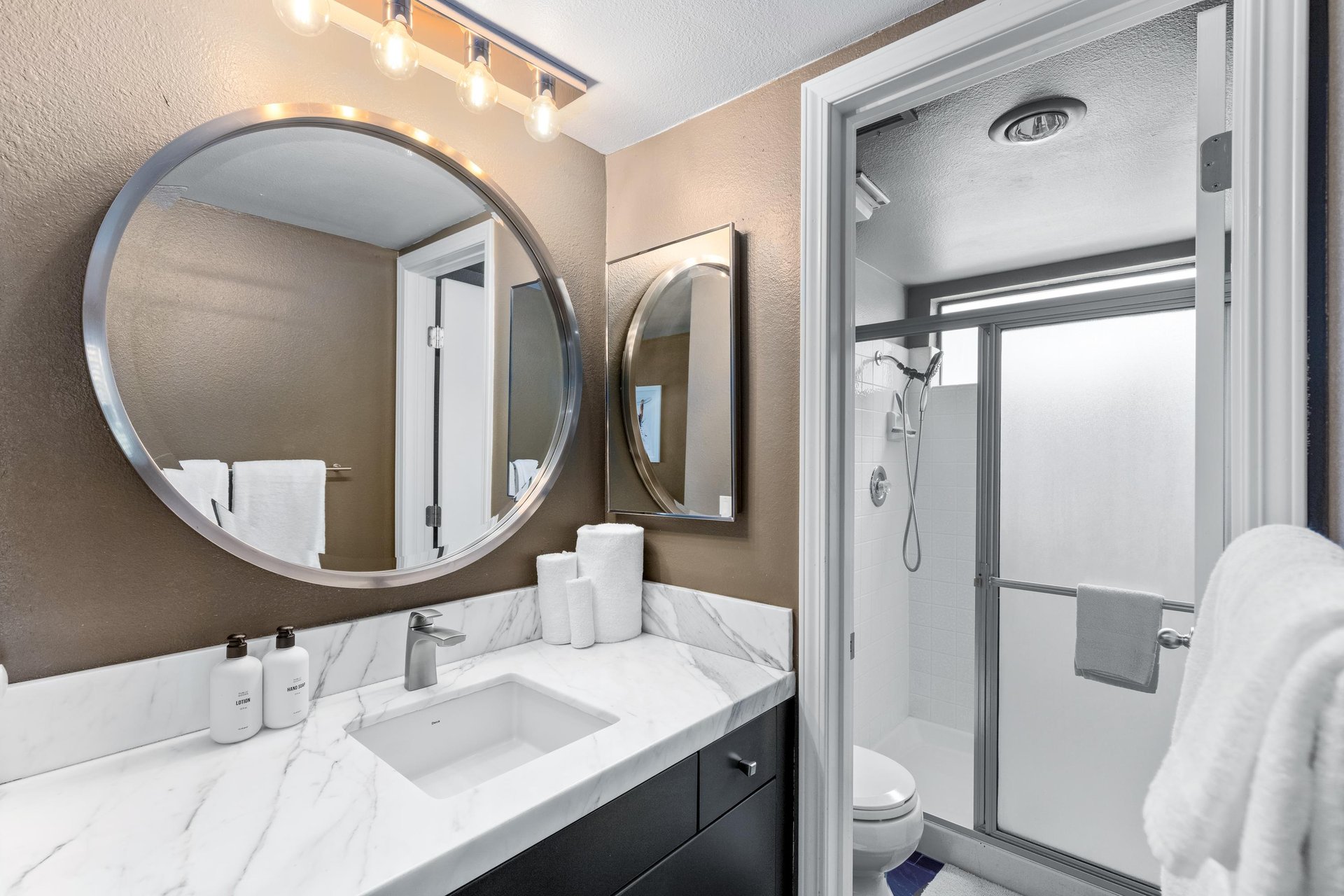 Modern fixtures and standalone shower.