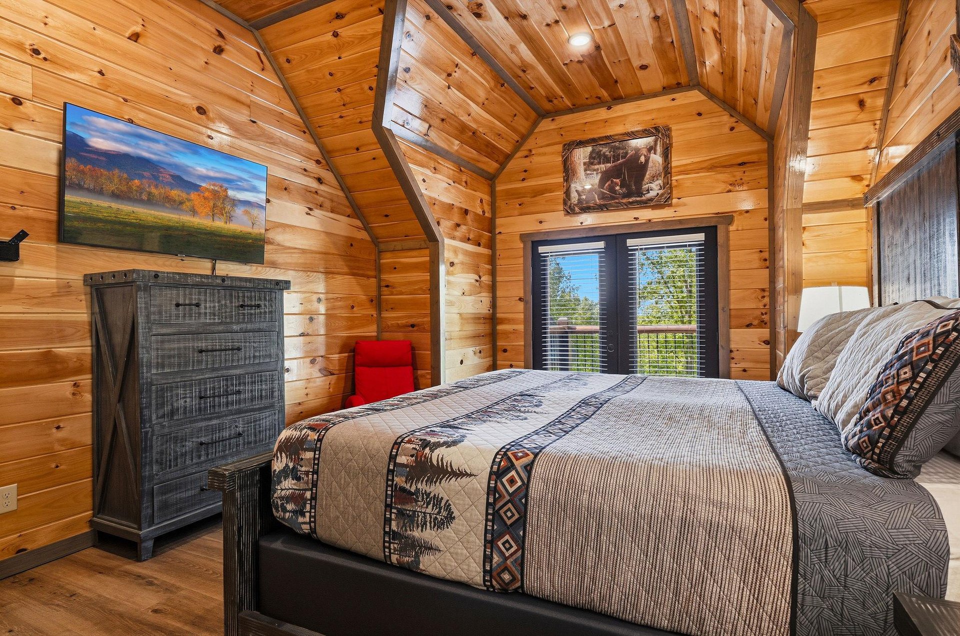 Drift off to sleep surrounded by warm wood walls and cozy cabin charm, with nature views from your private window.