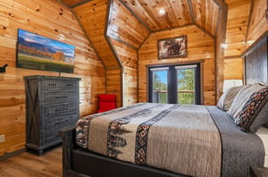 Drift off to sleep surrounded by warm wood walls and cozy cabin charm, with nature views from your private window.