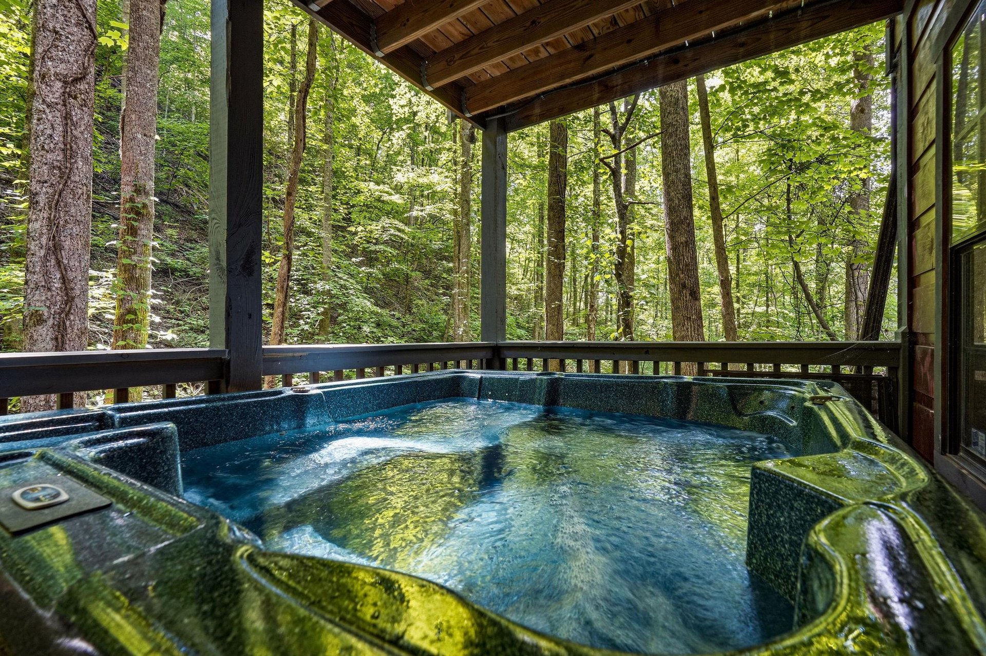 Sink into your private hot tub and let the peaceful forest surround you—pure relaxation awaits on your covered deck.
