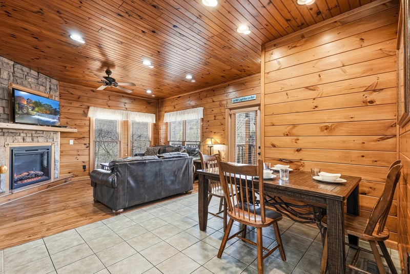 Curl up in your cozy cabin retreat, where warm wood surrounds you, a crackling fireplace invites you to unwind, and rustic charm meets modern comfort in every corner of your mountain escape.