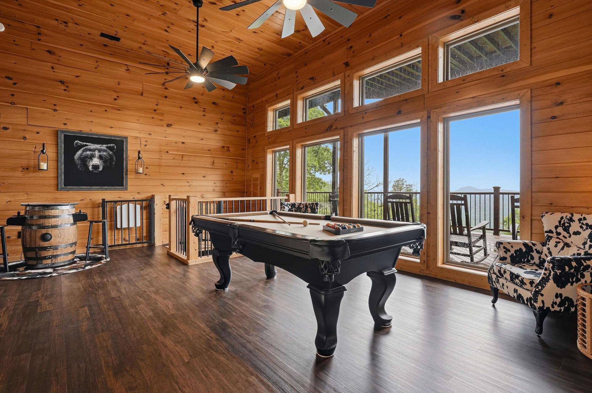 Challenge your travel companions to a game on the pool table while soaking in stunning views through floortoceiling windows. Rustic wood accents and cozy seating create the perfect retreat for your 