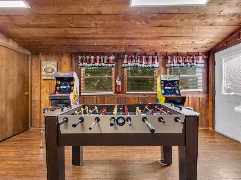Challenge friends to foosball while classic arcade games await your next turn in this cozy woodpaneled game room.