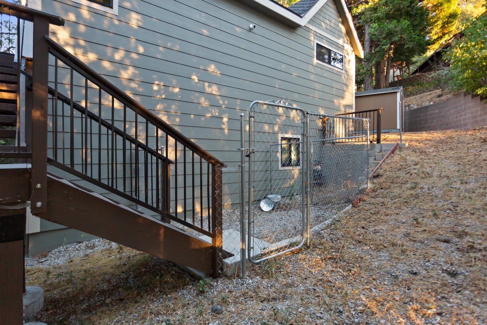Fenced dog area with doggie bags and trash bin for easy clean up.