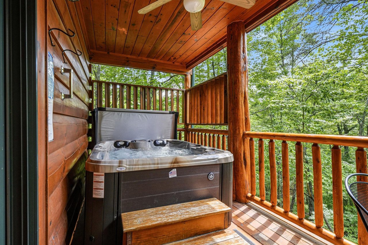 Soak in your private hot tub on your covered deck, surrounded by lush forest greenery. Let the warm jets melt your cares away in this peaceful treetop retreat.