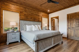 Step into this inviting bedroom where rustic charm meets modern comfort. The plush kingsize bed and warm wood accents create a peaceful retreat, perfect for unwinding after a day of adventure.