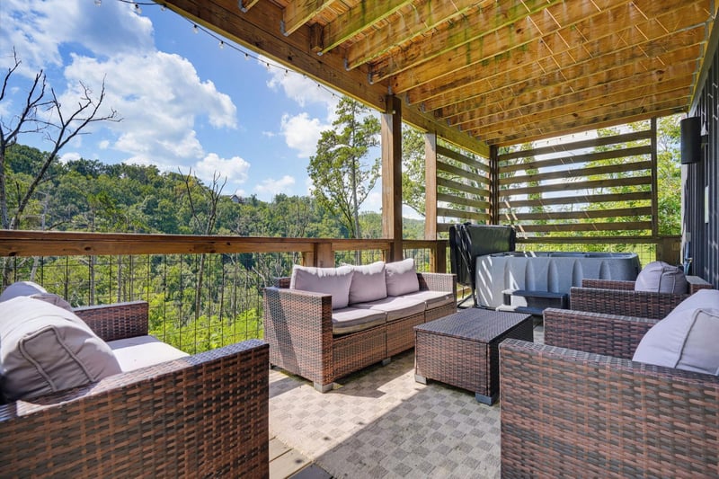 Picture yourself unwinding here on plush wicker seating, surrounded by lush mountain forest. The covered terrace invites you to savor fresh air and sweeping natural views in total comfort.