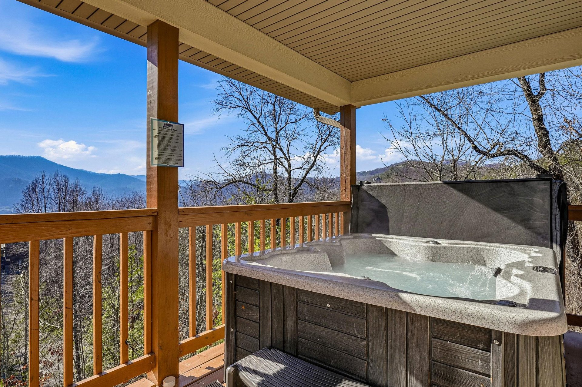 Soak in your private hot tub while taking in breathtaking mountain views from your covered deck.