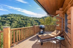 A chaise lounge on the deck overlooking the mountains at Great View Lodge, a 5bedroom cabin rental located in Pigeon Forge