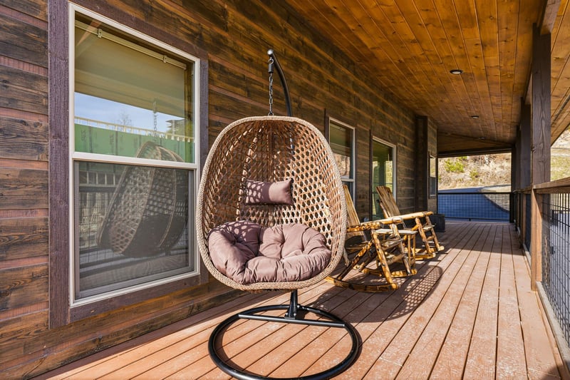 Unwind in your private hanging egg chair on the covered deck, surrounded by warm wood and peaceful views.