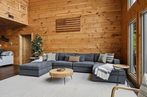 Picture yourself unwinding in this warm, lightfilled living space with soaring wood walls, a plush sectional, and modern touches that create the perfect mountain retreat atmosphere.