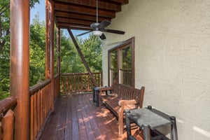 Bench on a deck at Graceland, a 4bedroom cabin rental located in Pigeon Forge