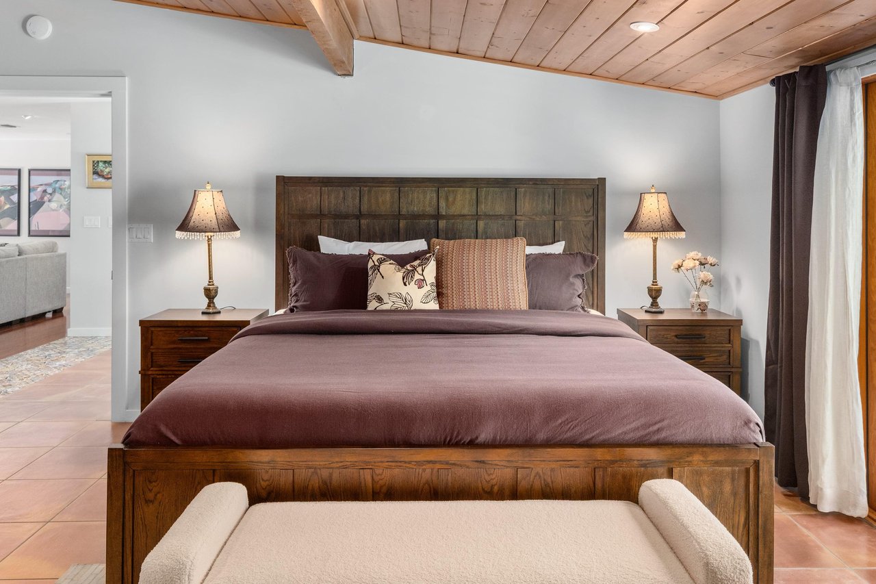 King bed, smart TV, patio access, and ensuite bathroom.