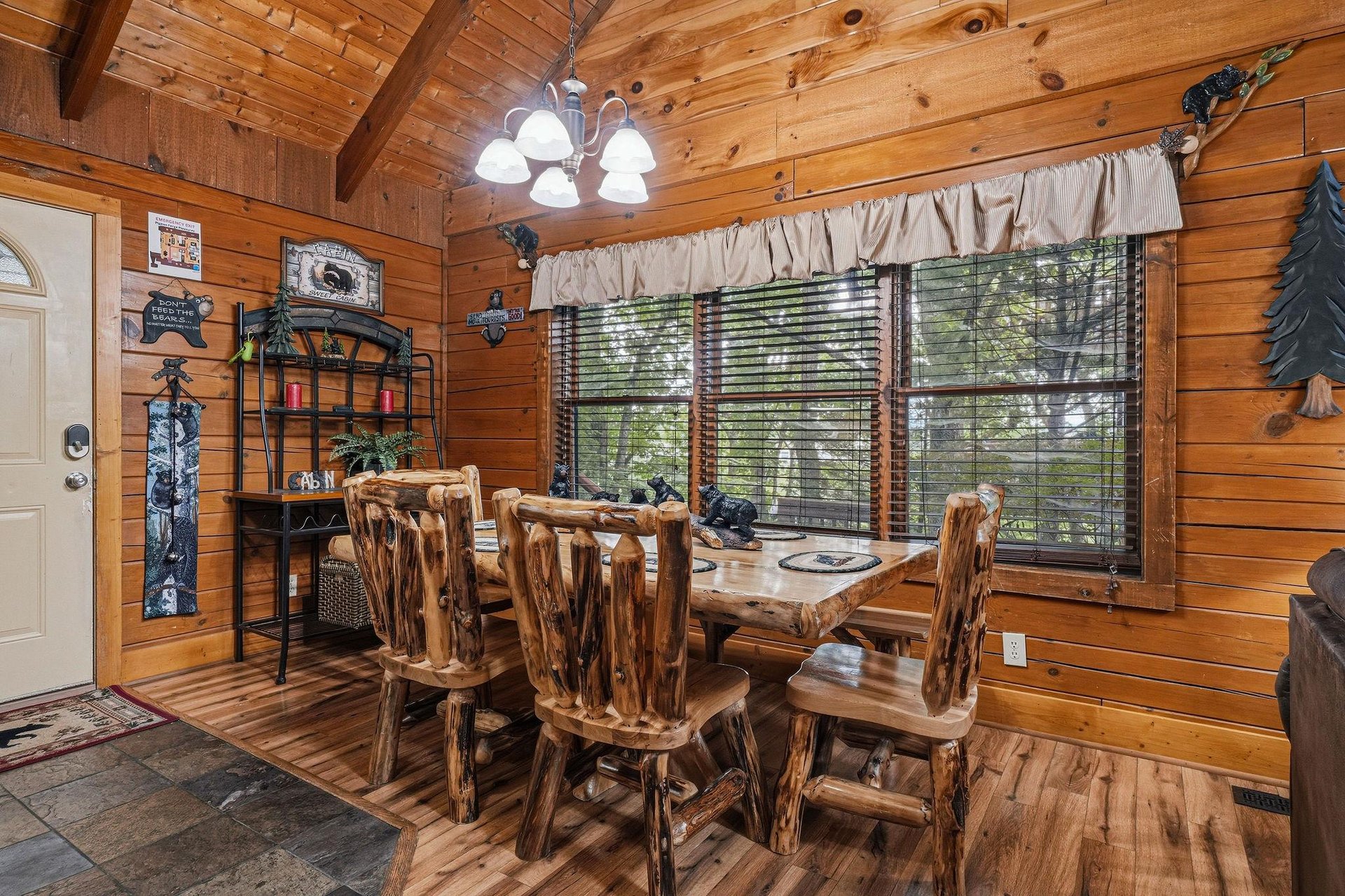 Gather around this handcrafted log dining table in your cozy mountain cabin, where warm wood walls and natural light create the perfect setting for meals with loved ones.