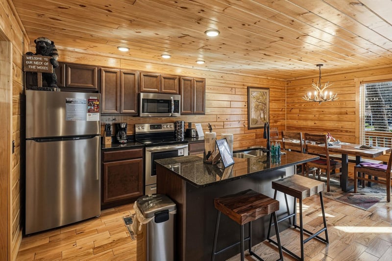 Gather around this spacious kitchen island where youll prepare meals together, surrounded by warm wood beams and modern appliances.