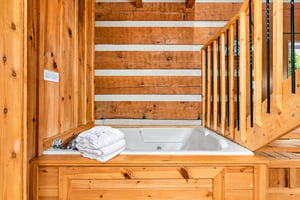 Slip into your private soaking tub surrounded by warm wood and natural light—perfect for unwinding after a day of adventure.