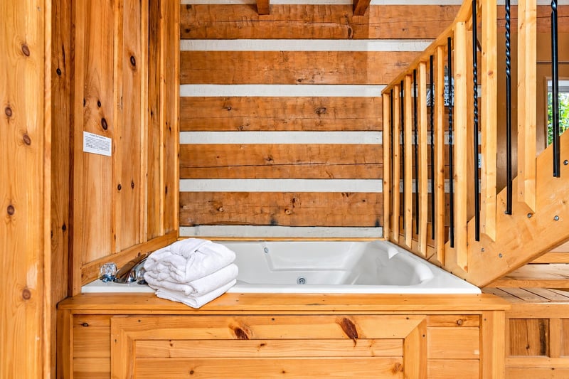 Slip into your private soaking tub surrounded by warm wood and natural light—perfect for unwinding after a day of adventure.