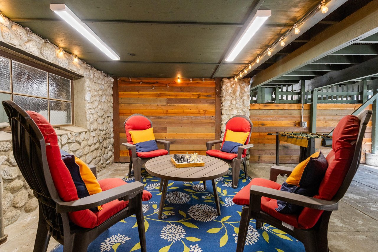 Below the deck is another outdoor seating area with games.