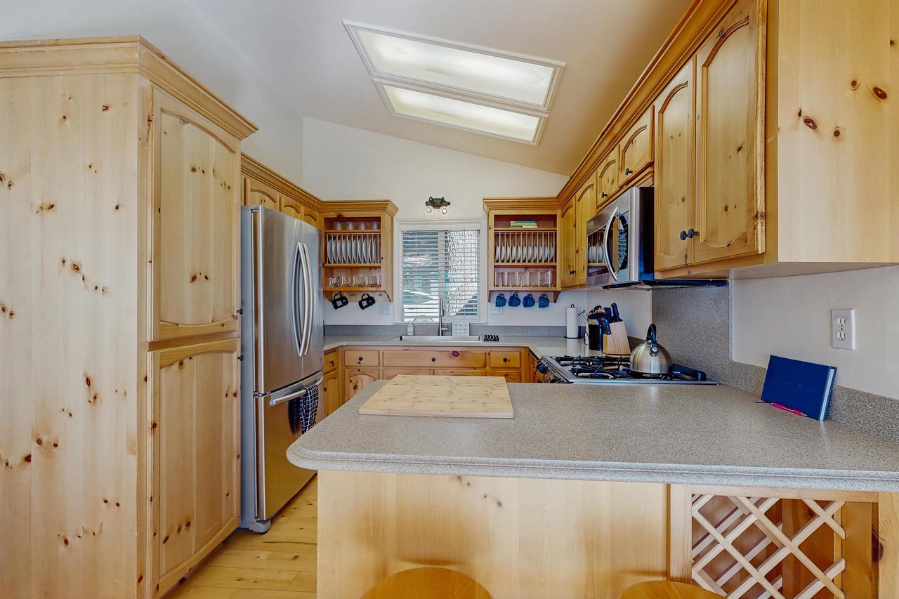 Stainless steel appliances, counter seating for 2, and kitchen essentials.