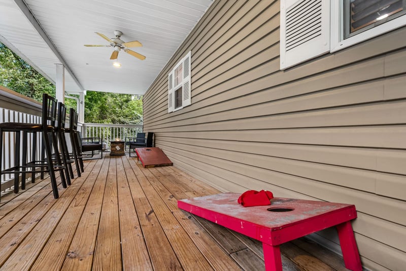 Corn hole boards on back deck with seating