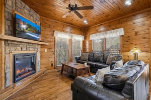 Sink into plush leather seating by your own stone fireplace, where natural wood surrounds you and mountain views frame your peaceful escape through every window.