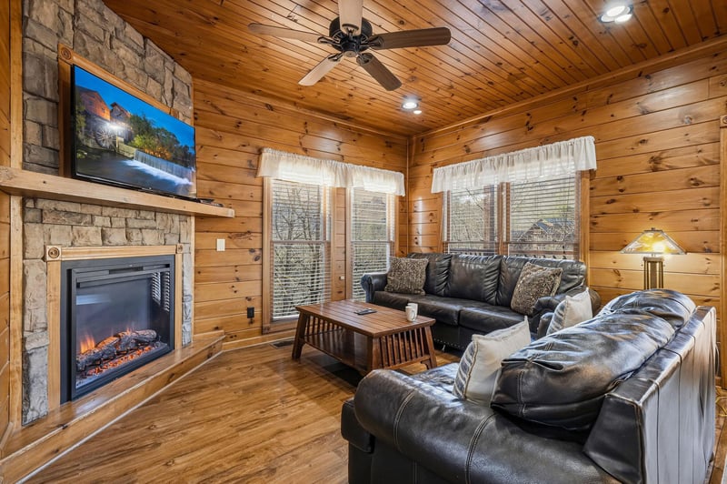 Sink into plush leather seating by your own stone fireplace, where natural wood surrounds you and mountain views frame your peaceful escape through every window.